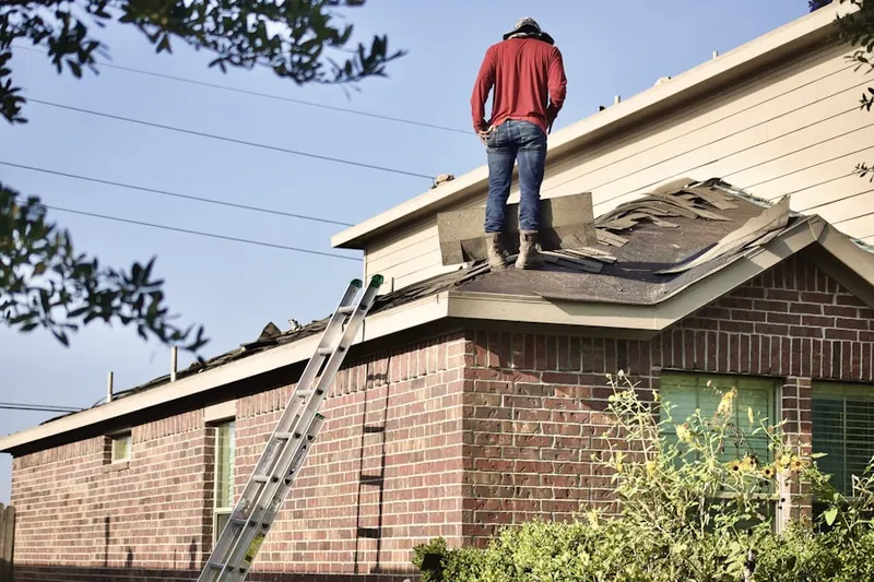 Professional roofer working on a residential roof in Demorest